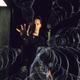 Keanu Reeves as Neo in The Matrix holding out his hand with magical spirals or something appearing to emanate from him.